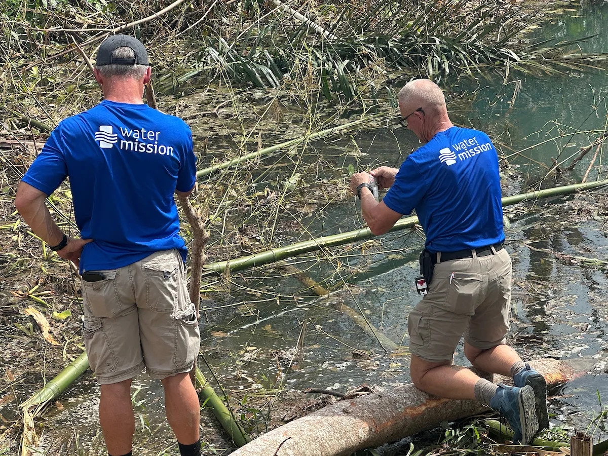 Men in blue polos conduct analysis of dirty water