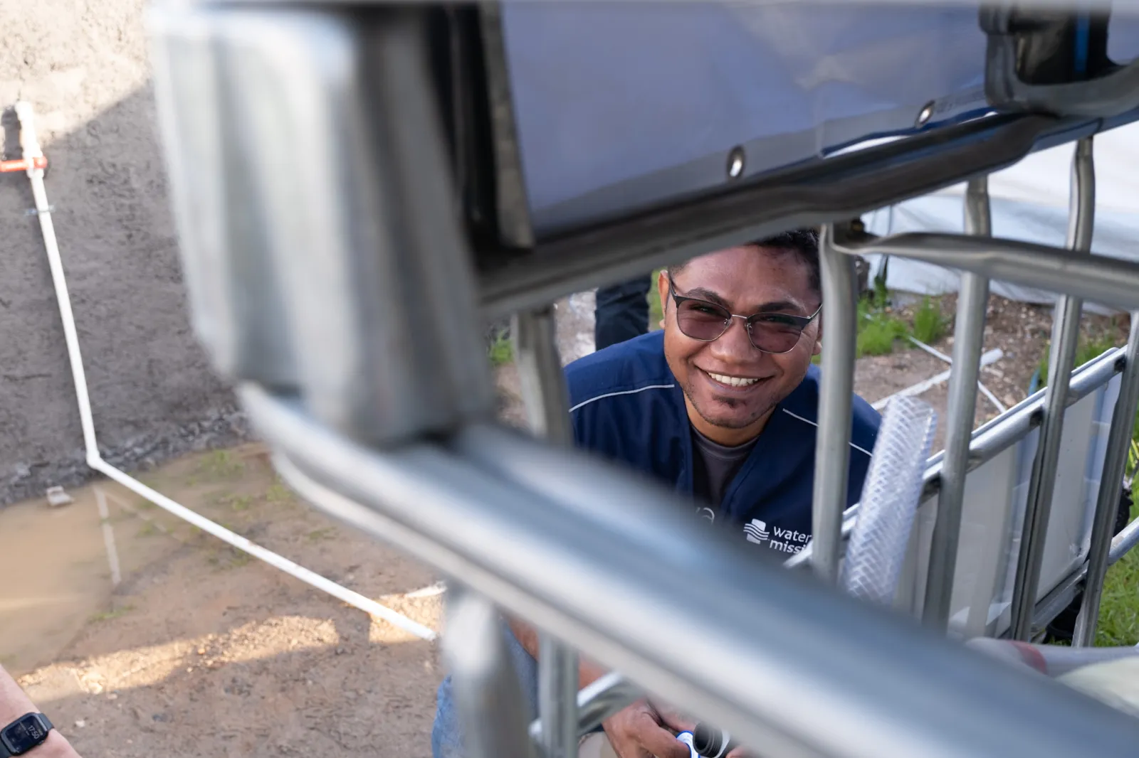 A Water Mission team member installs a water system