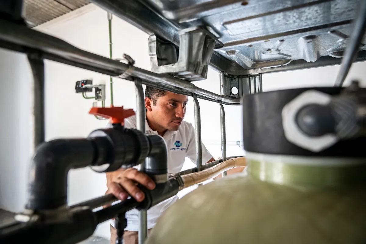 A Water Mission team member inspects a water treatment systen in Guadelupe Victoria, Mexico