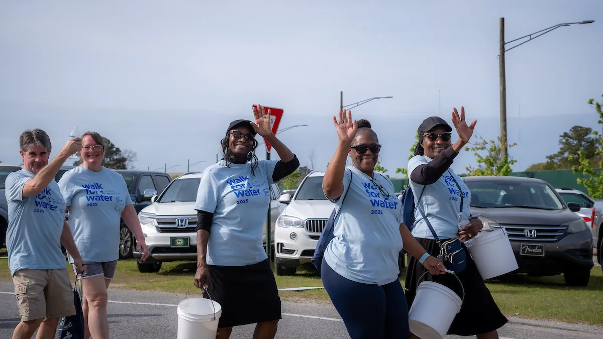 Walkers waving and smiling