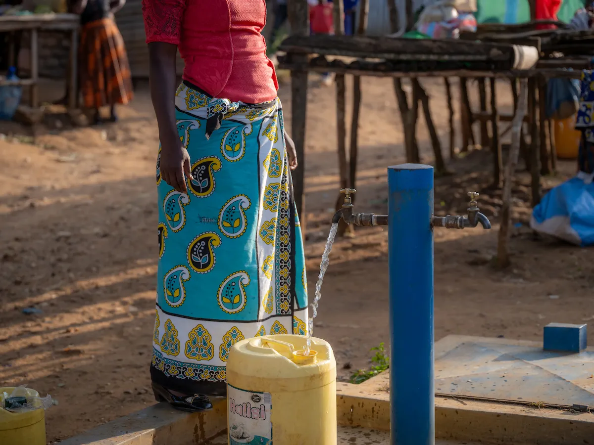 Woman fills jerry can with water