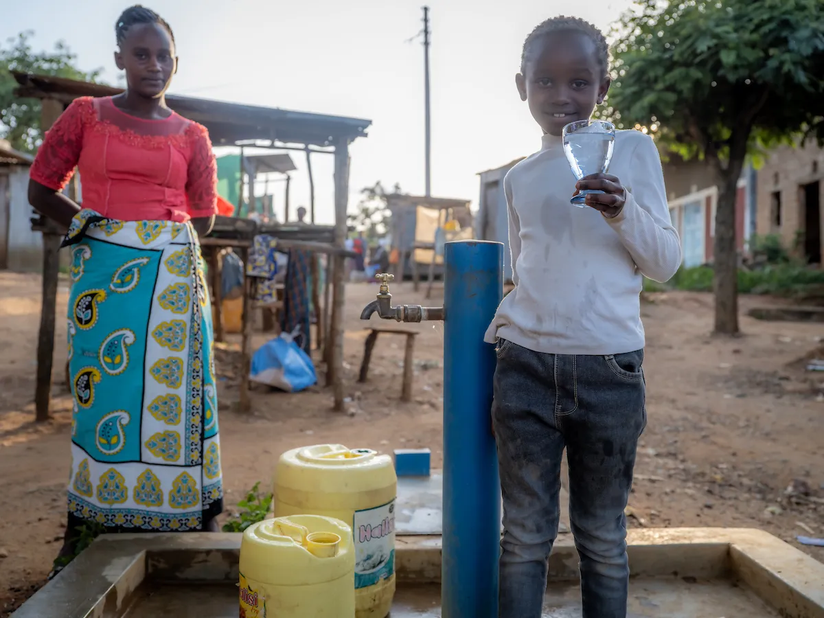Girl holding glass of water