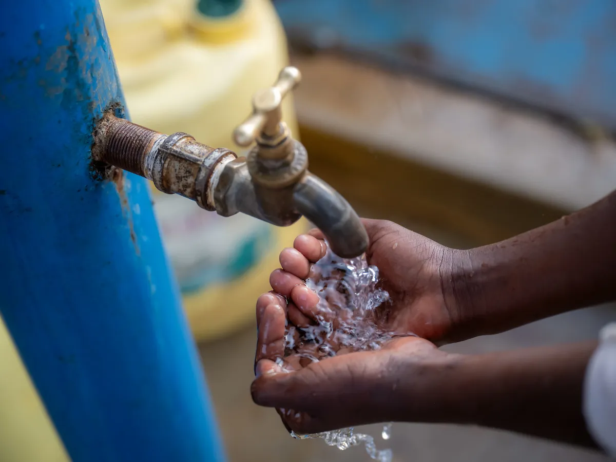 Hands catching water from tap