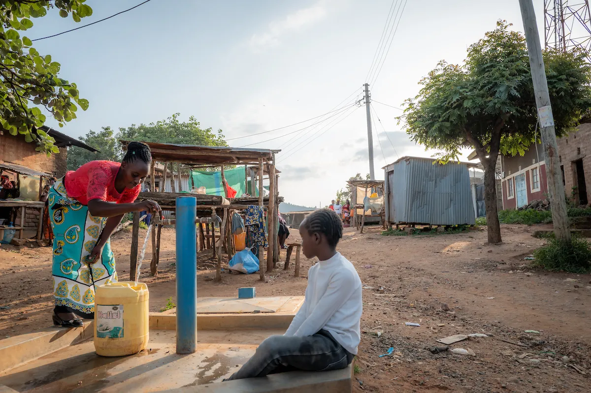 Mother and daughter fetching water