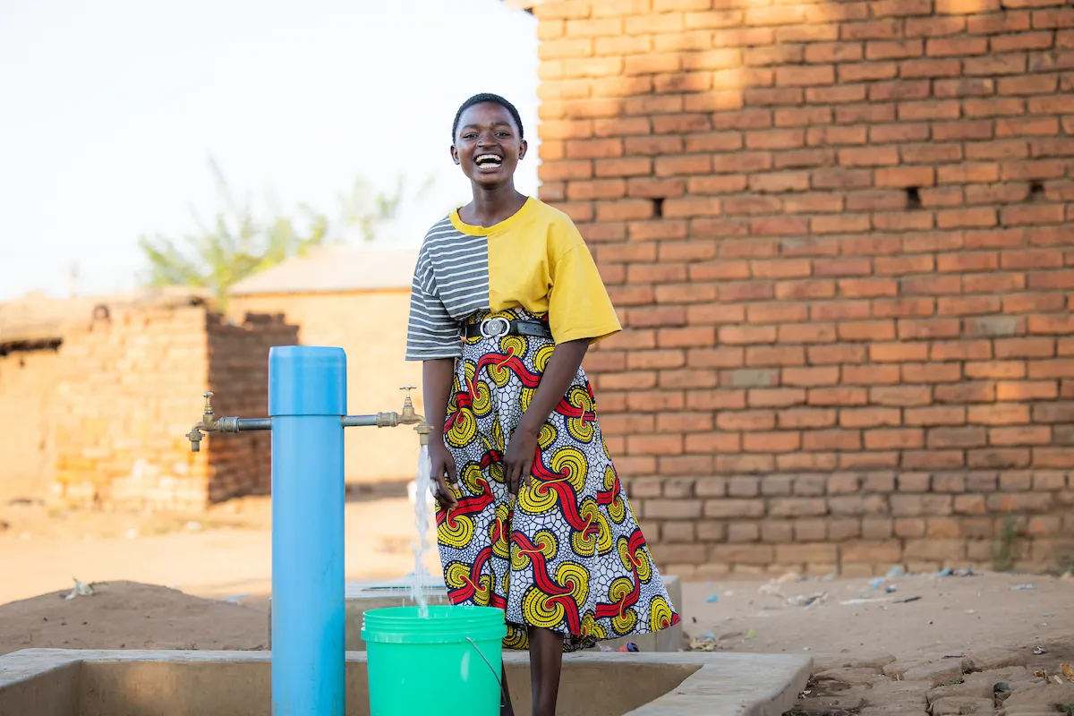 Gladys at a tapstand in Malawi