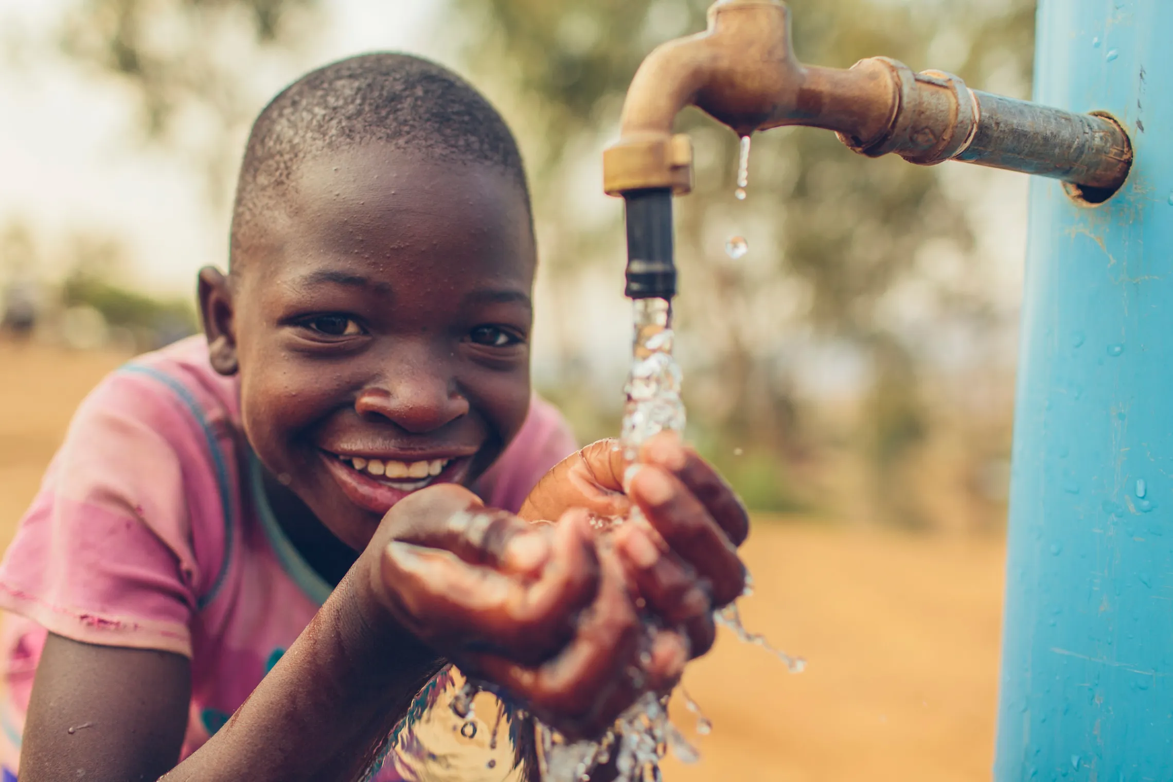 Boy washing hands with safe water