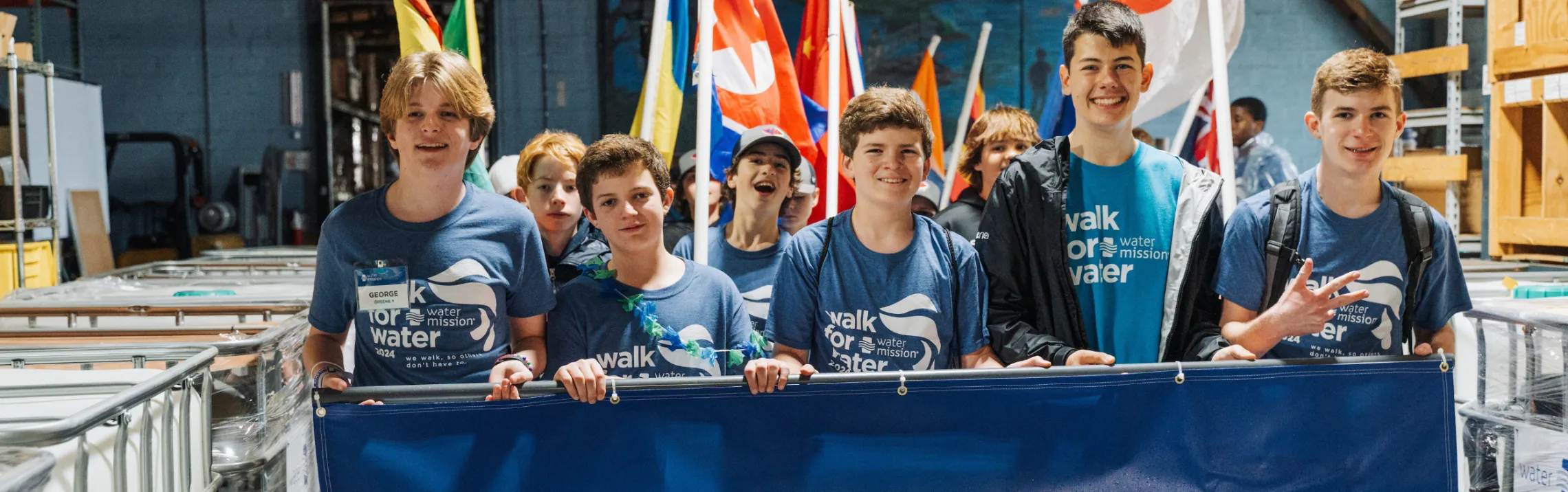 Boys carrying a banner and leading the Walk for Water 