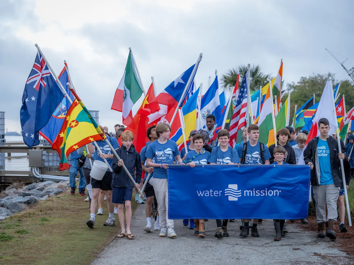 Walkers carrying a Water Mission banner