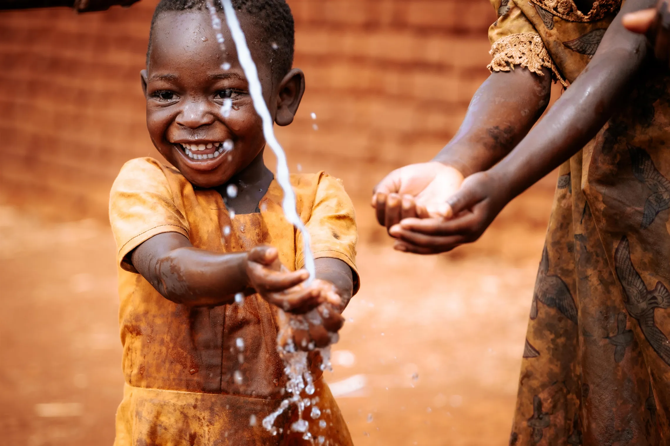 Girl washing hands with safe water