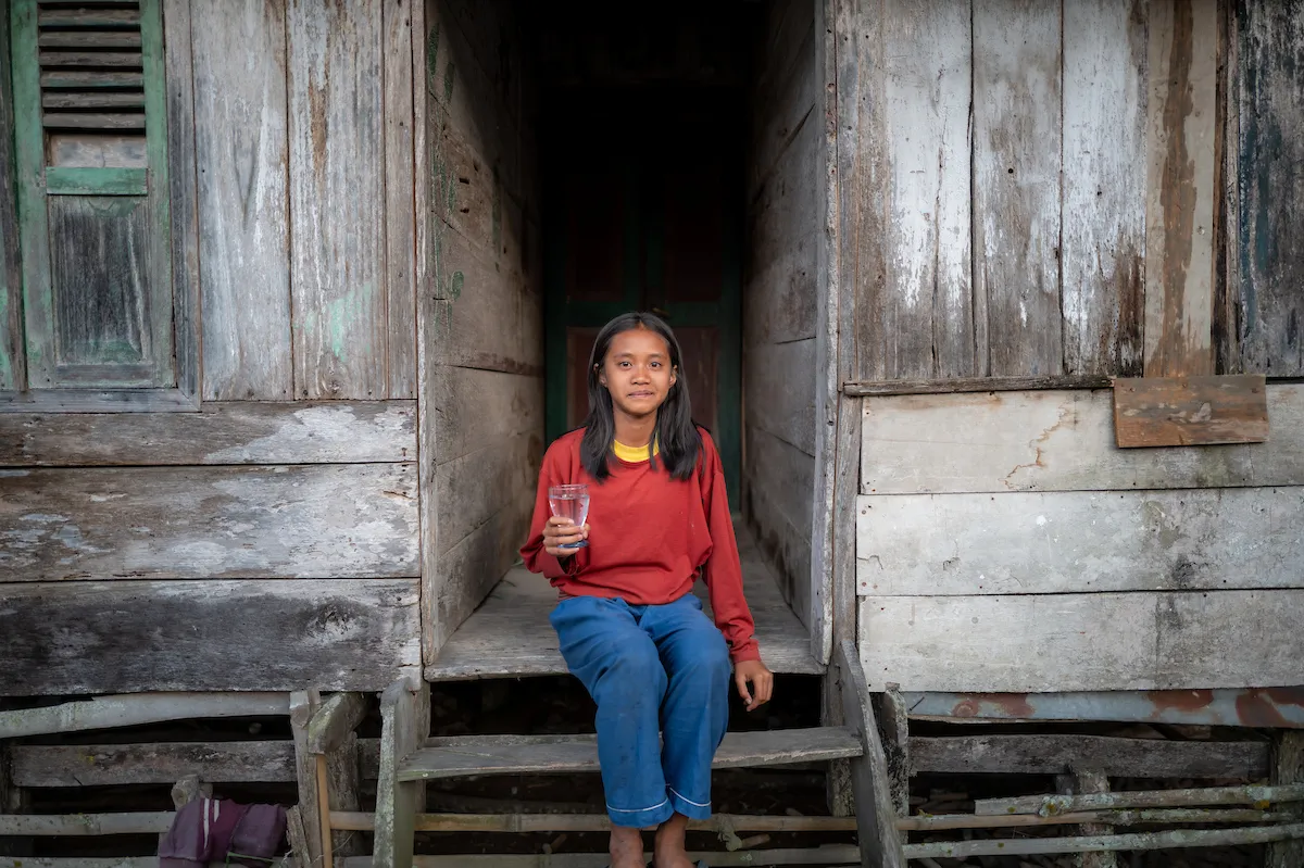 Renatal holds a glass of water