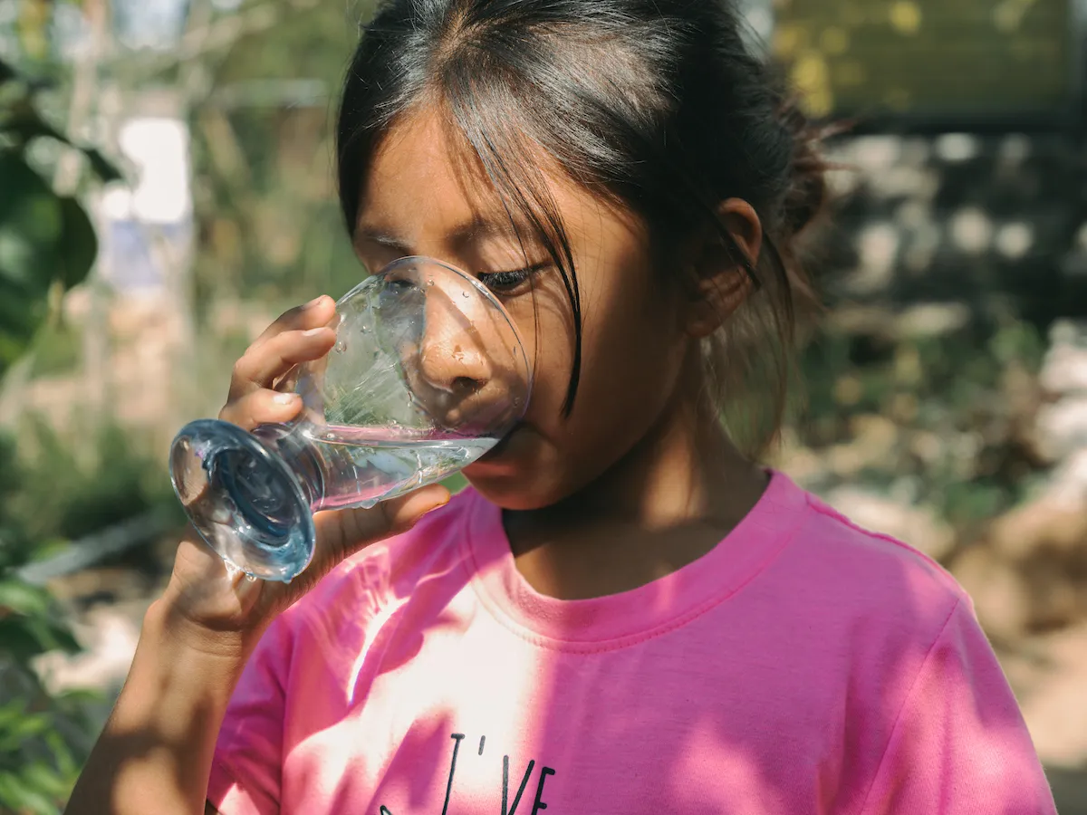 A girl from Mexico drinks water