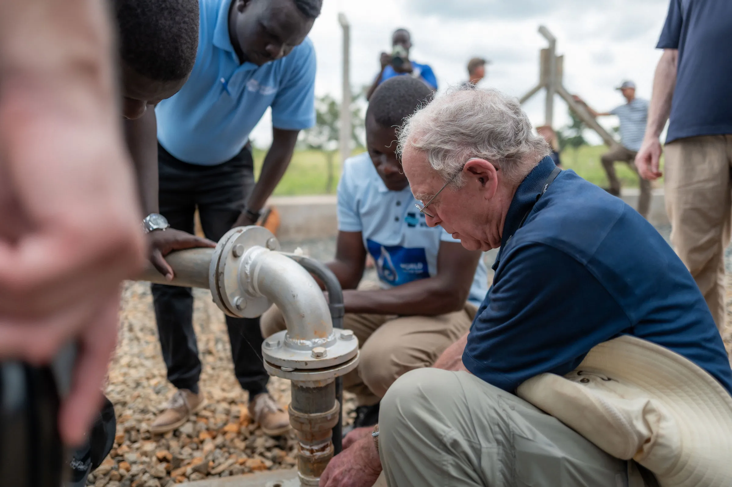 Water Mission Co-Founder George Greene III Inspects a Pipe Fitting at a Safe Water Project