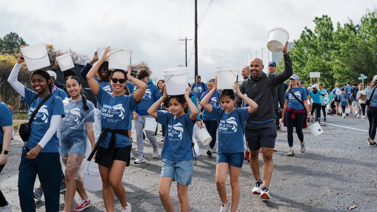 Walkers carrying buckets on their heads