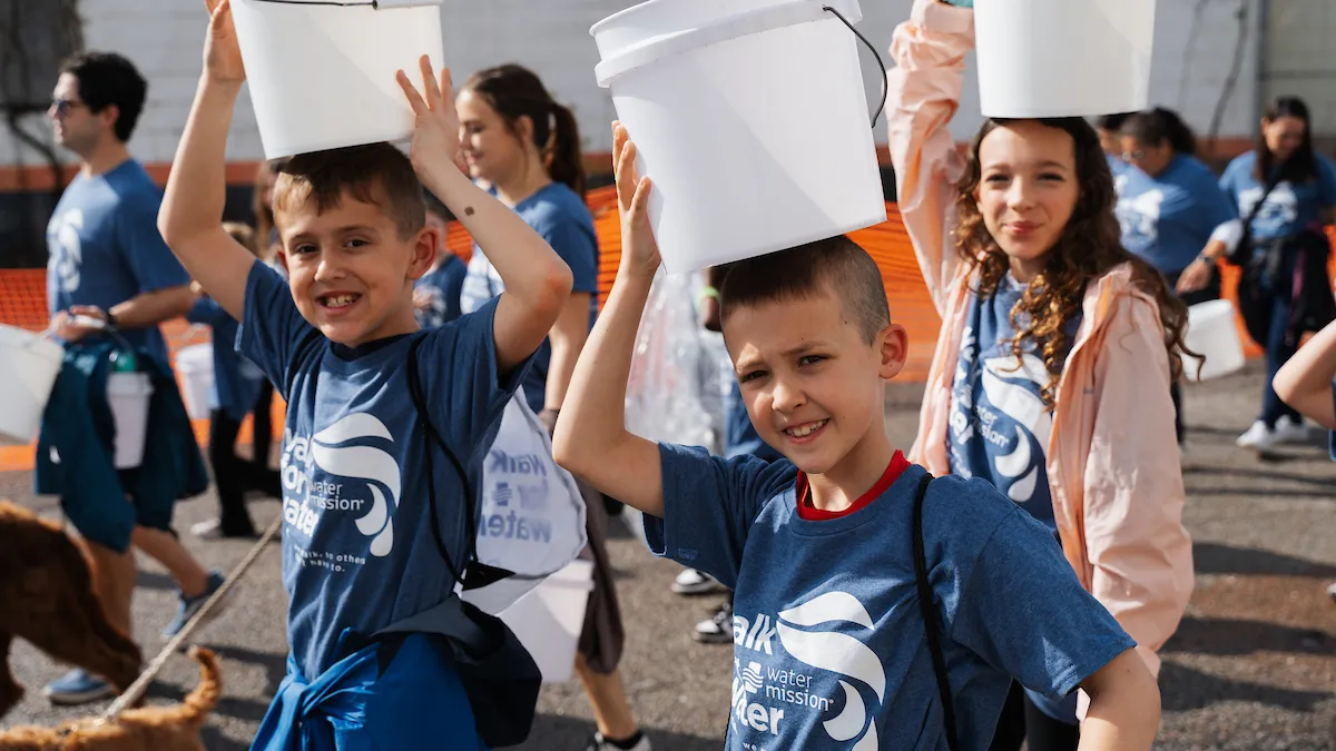 Kids walking with buckets