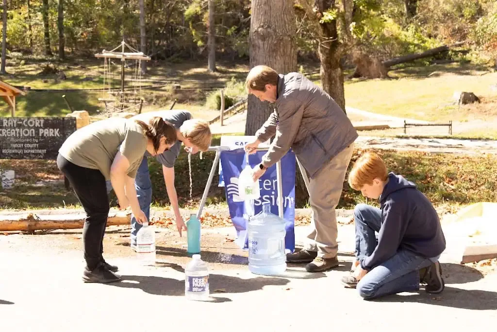 Water Mission CEO and president George Greene IV and sons