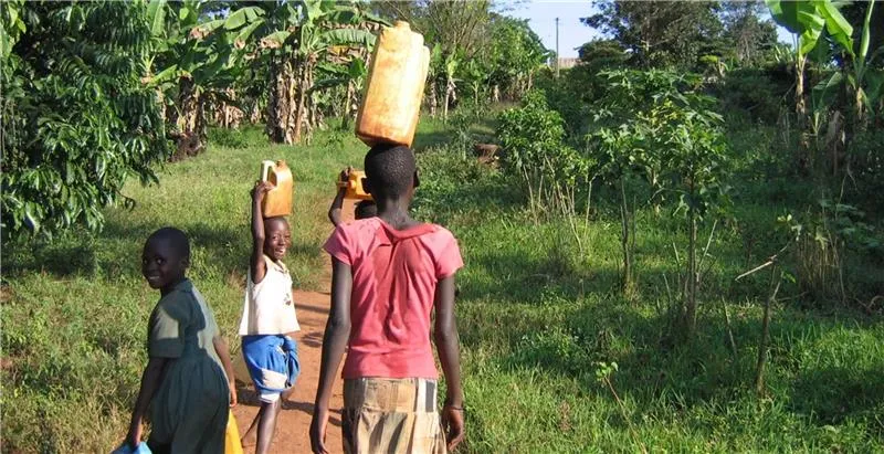 Jacqueline walking with jerry can