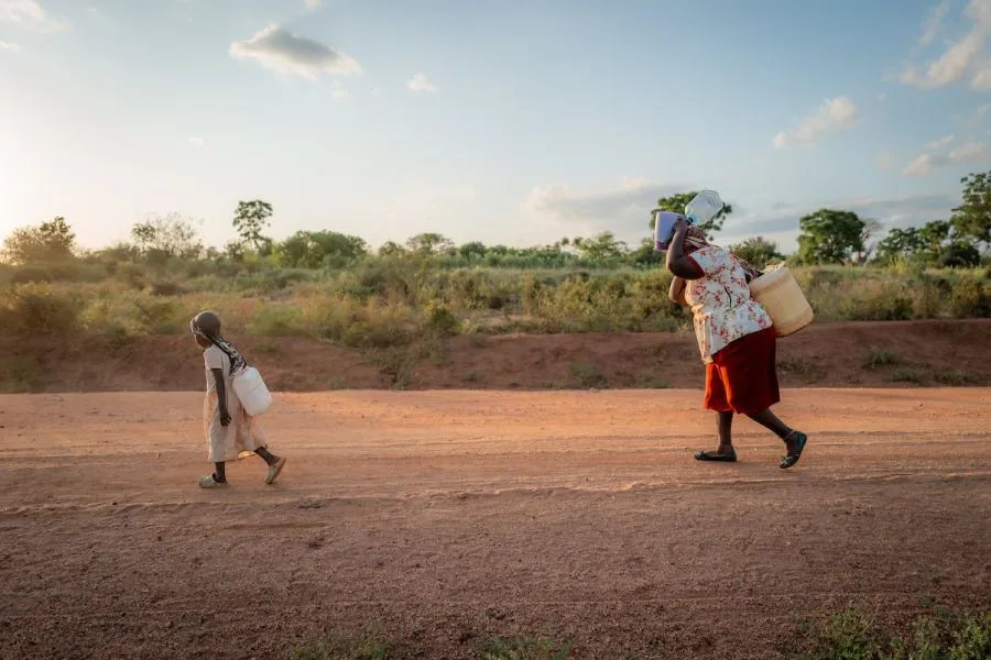 Celestine and her Grandma Anne walk two miles round-trip each day to collect water for their family.