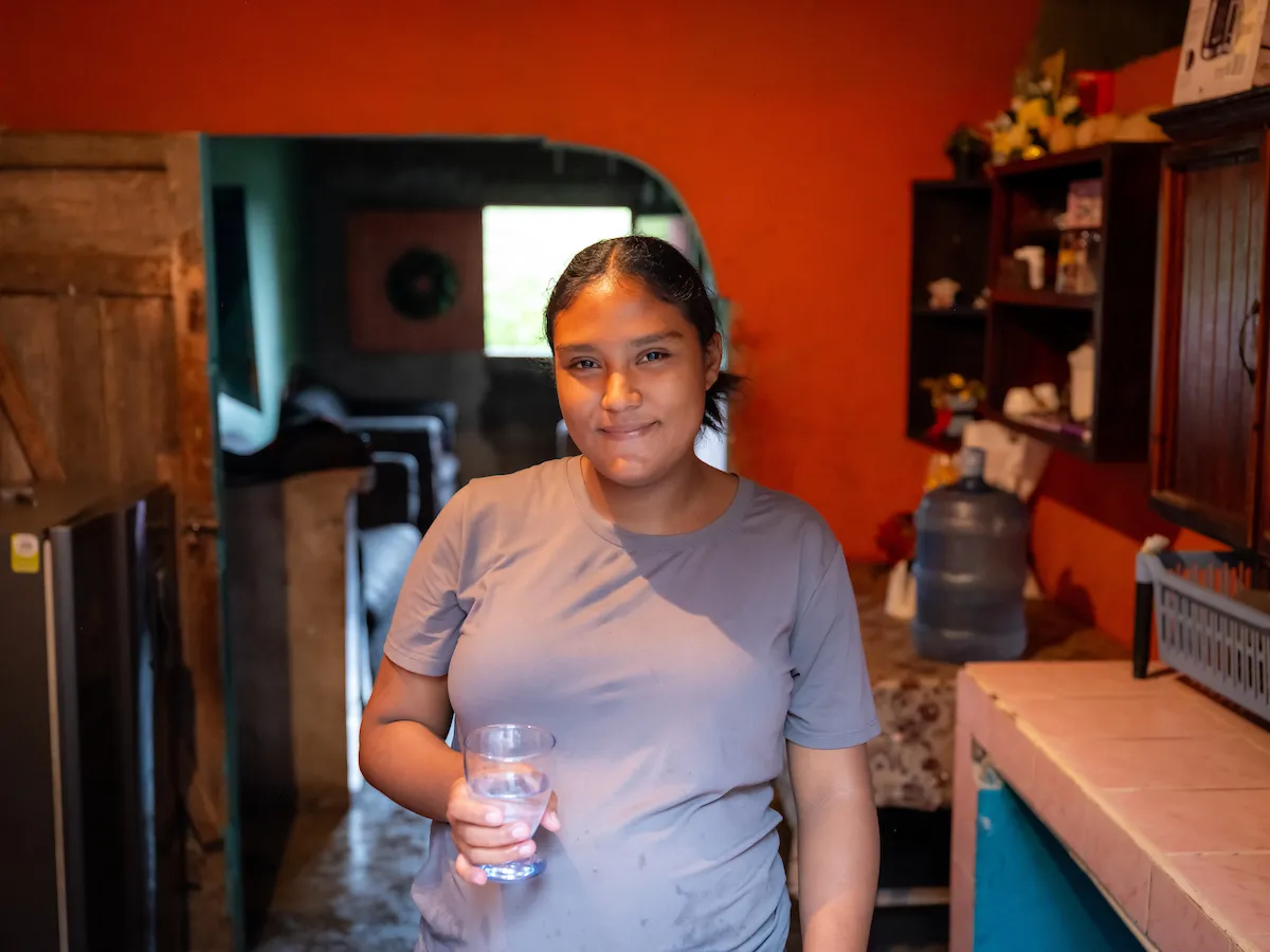 Marilyn holds a glass of water