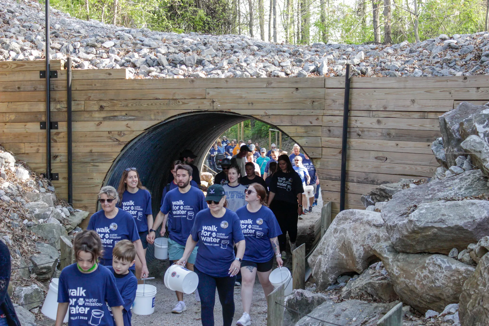 Walkers carrying buckets