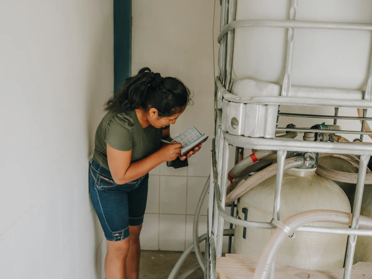 Cecilia using her skills to service a treatment system