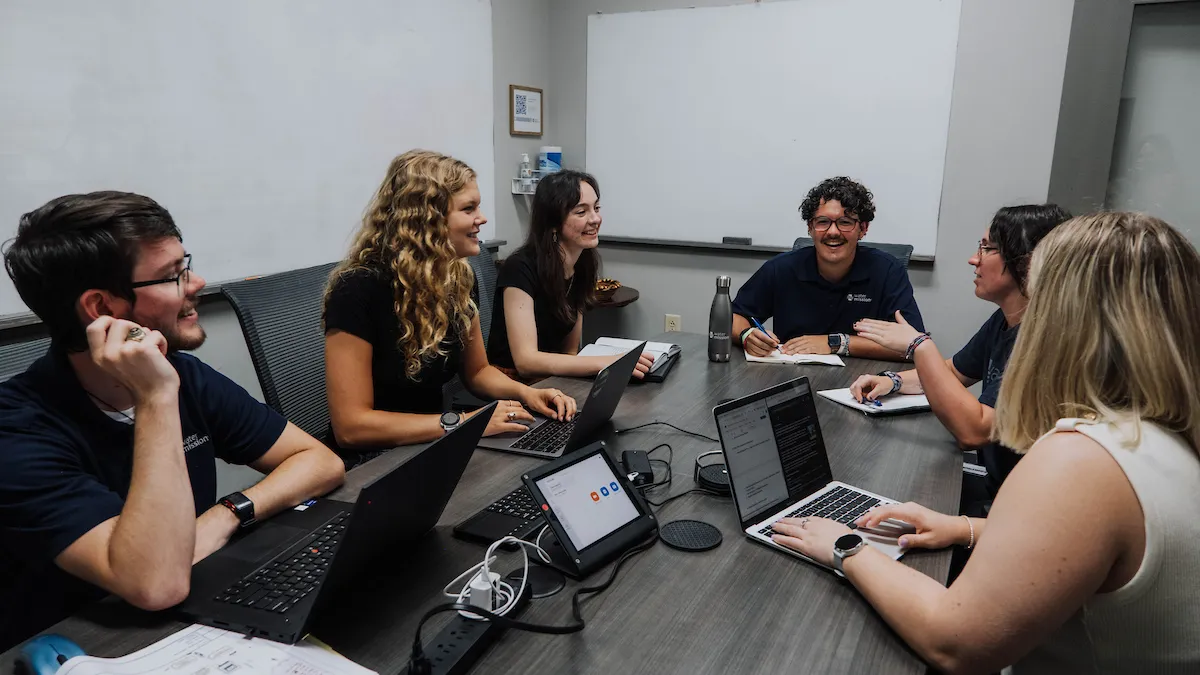 Interns at a conference table