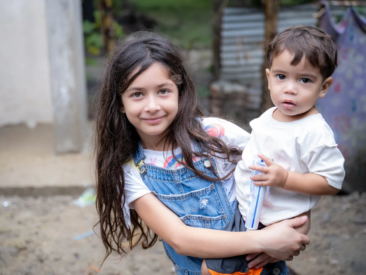 Two children pose for photo