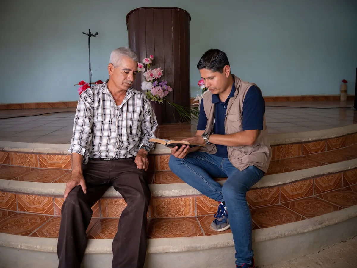 Pastor and Water Mission staff member read the Bible
