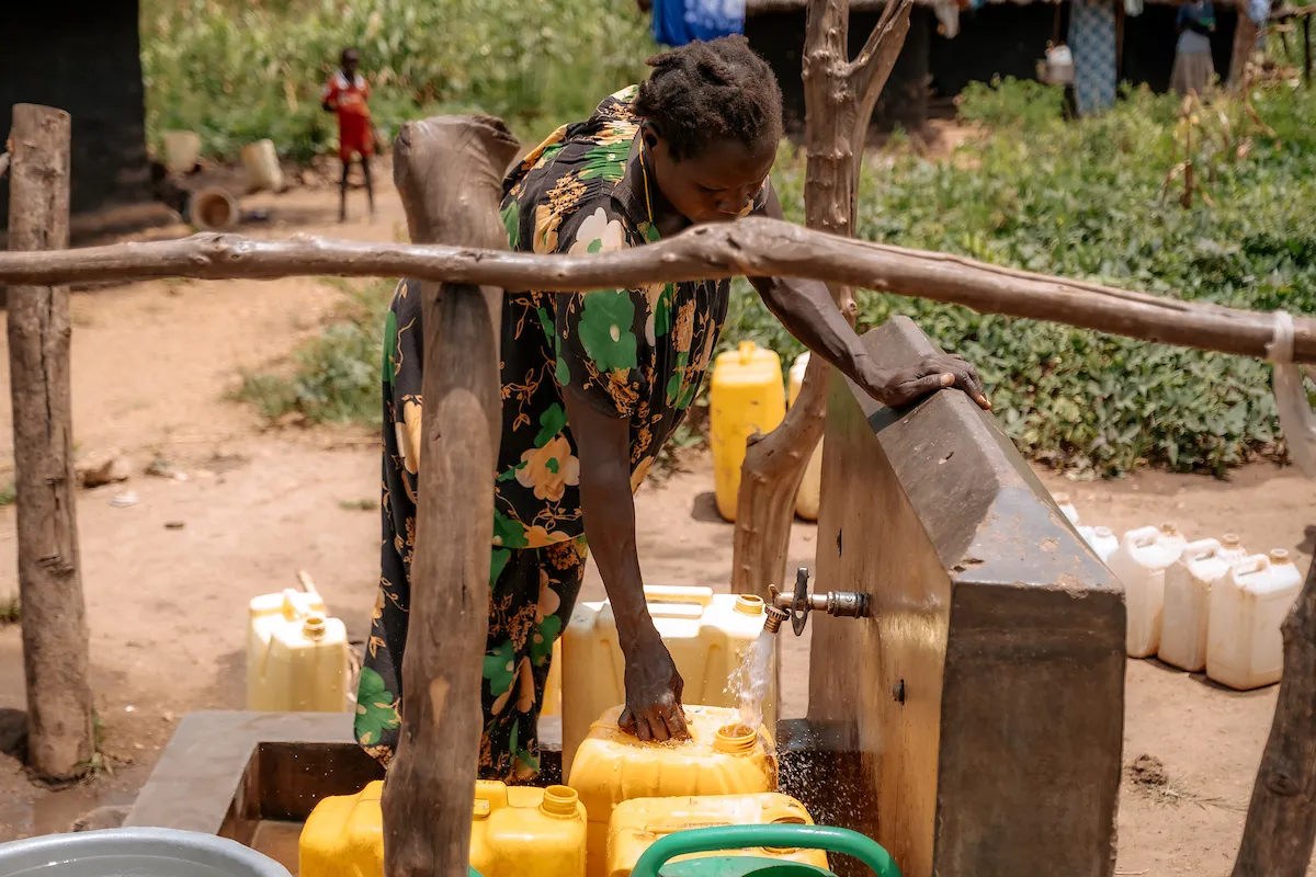 A woman collects safe water