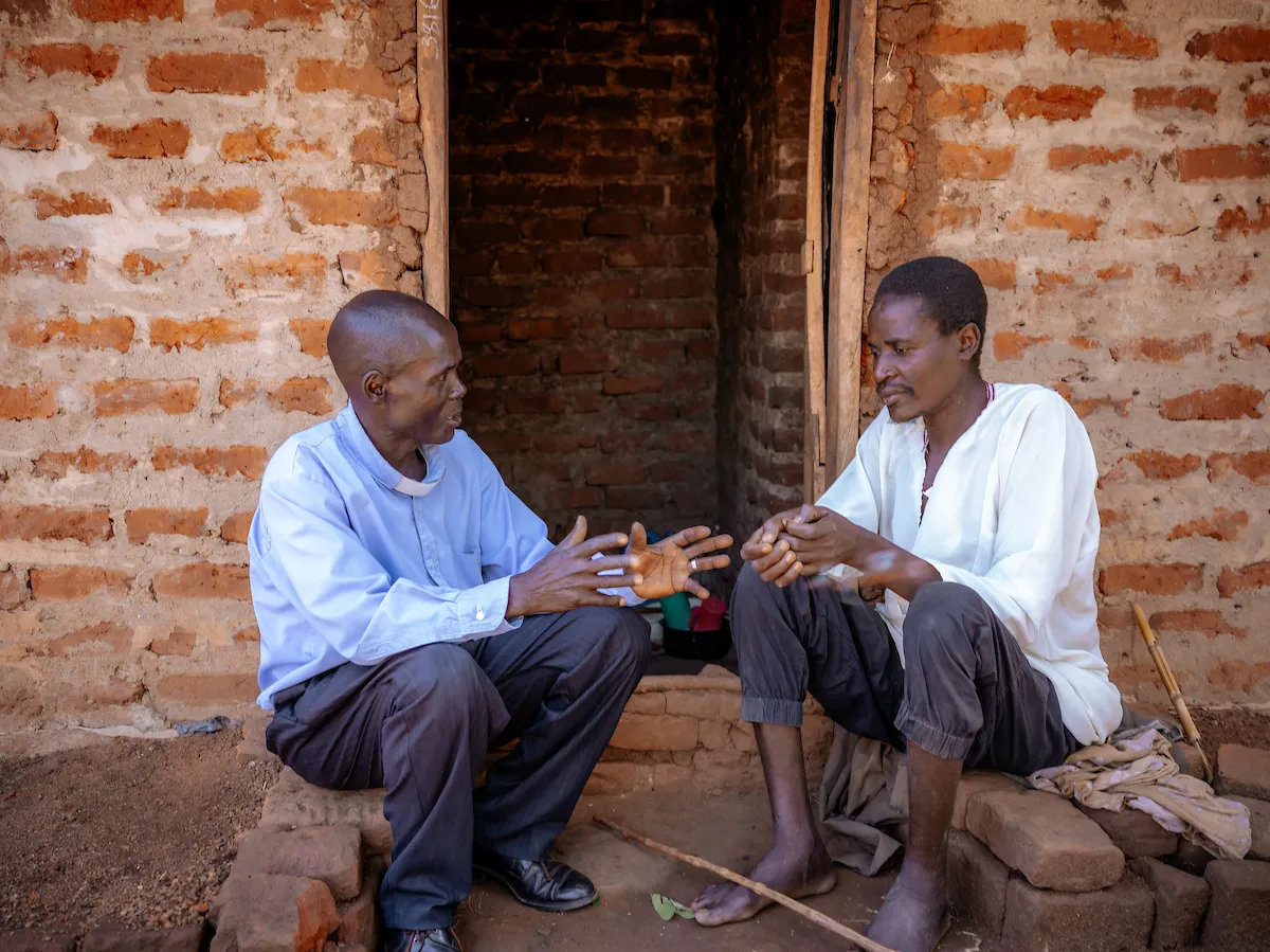 Pastor Laston in Uganda ministers to a blind man