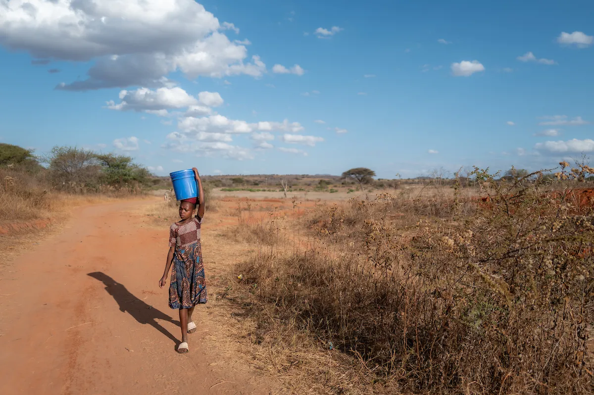 Child in Tanzania, Africa walks for water