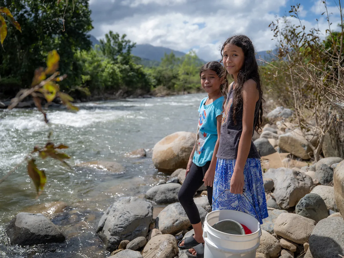 Young girls in Honduras at their local water source