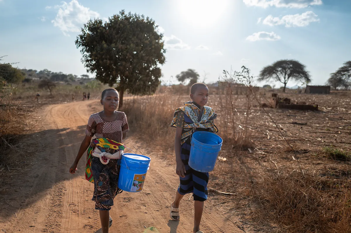 Neema and Recher walk for water in Tanzania, Africa