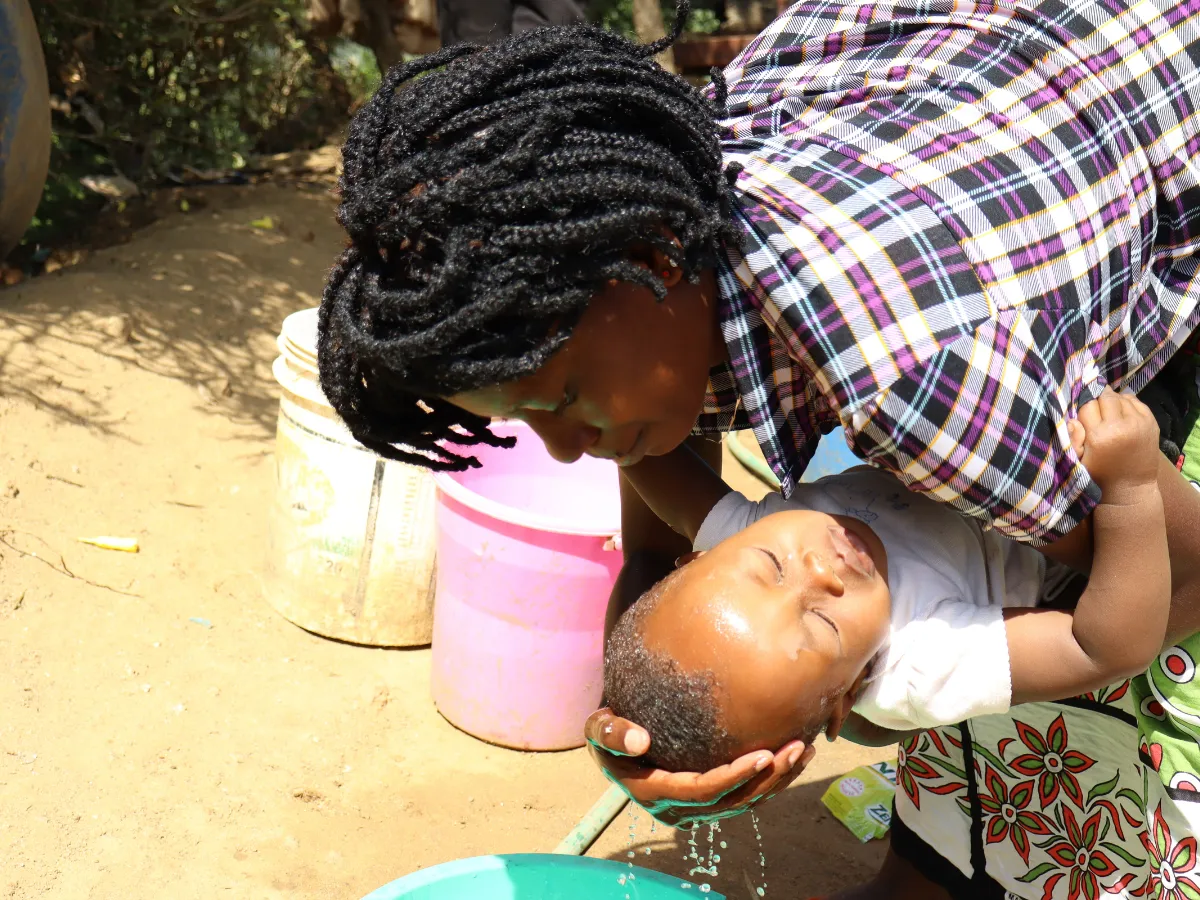 Rose bathes her child in Kenya, Africa