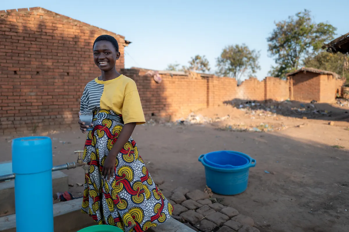 Gladys at a tapstand in Malawi