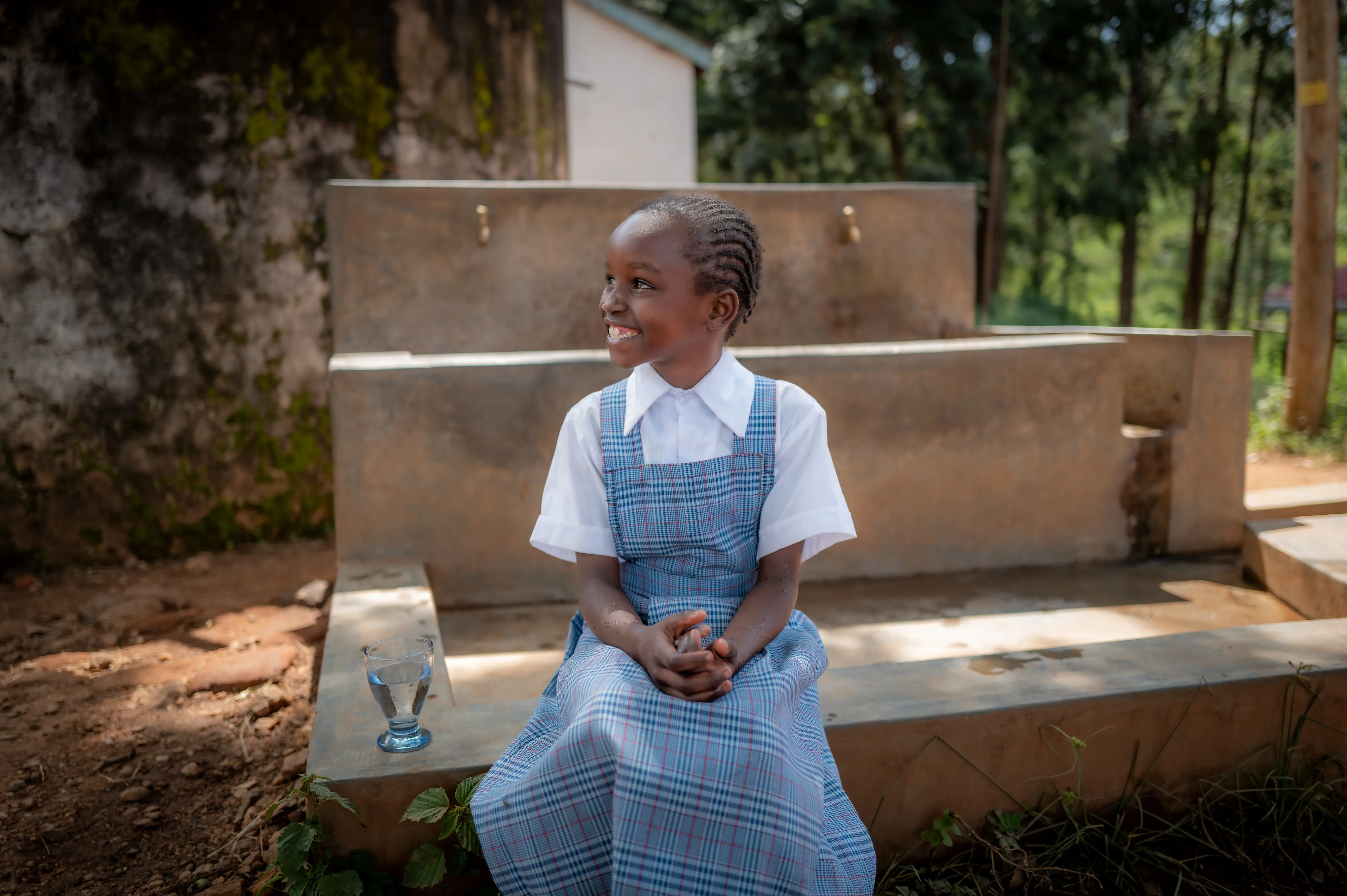 Girl sitting near tap stands