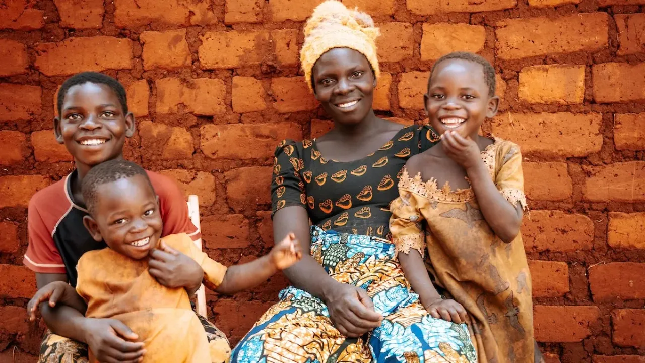 Mother and children smiling in Tanzania