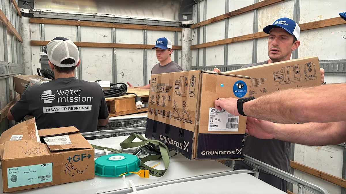 Water Mission team working with Grundfos equipment.