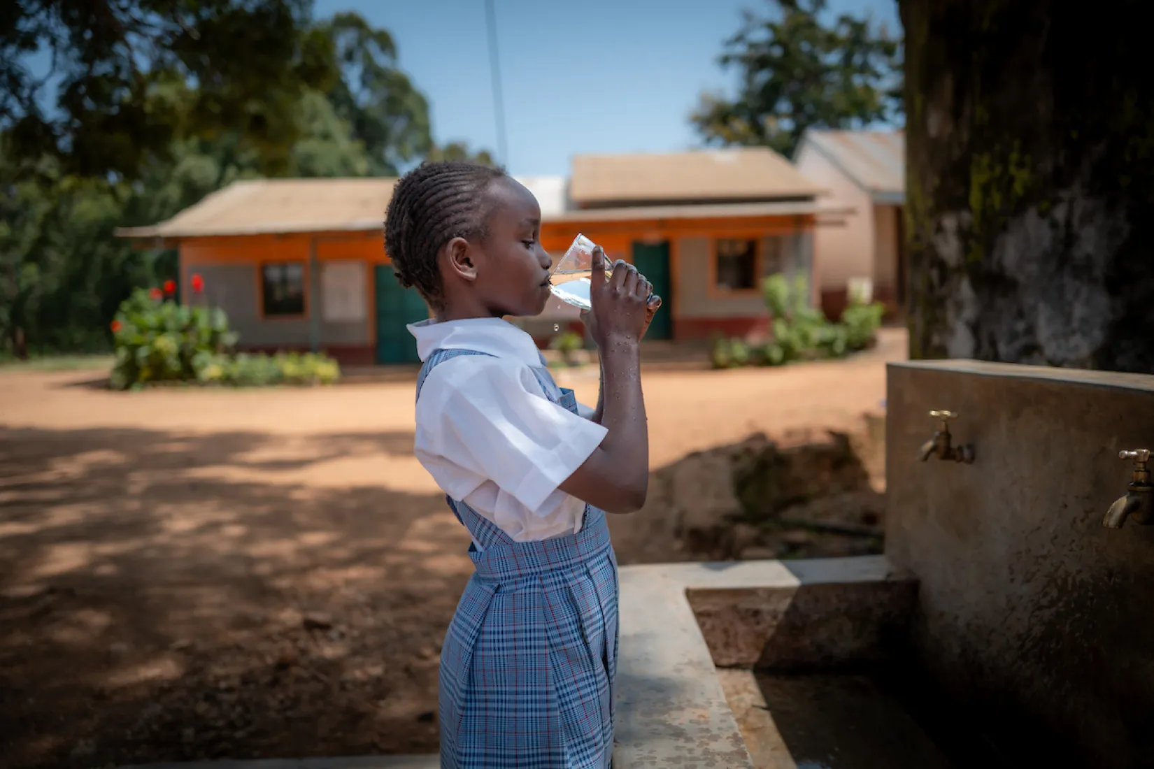Girl in Kenya, Africa drinks safe water