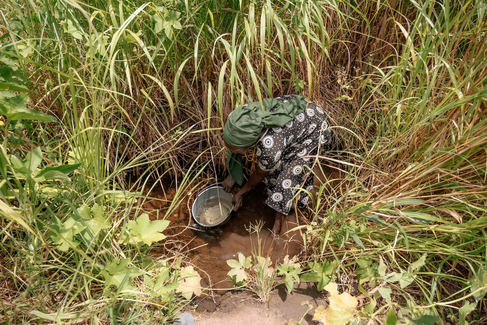 A woman in Africa fetching dirty water