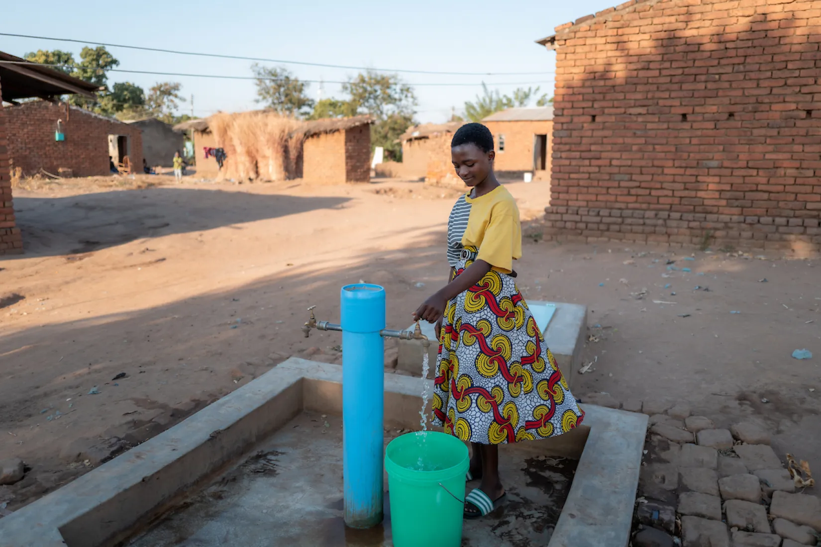 Gladys at a tapstand in Malawi