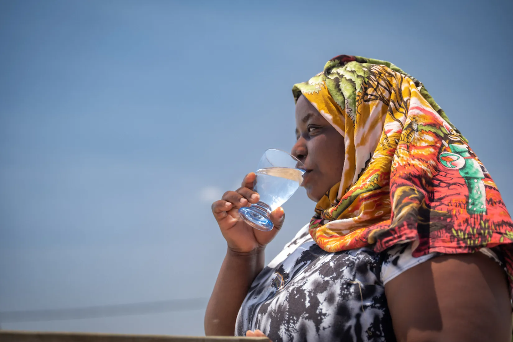 Pendo sips from a glass of safe water 