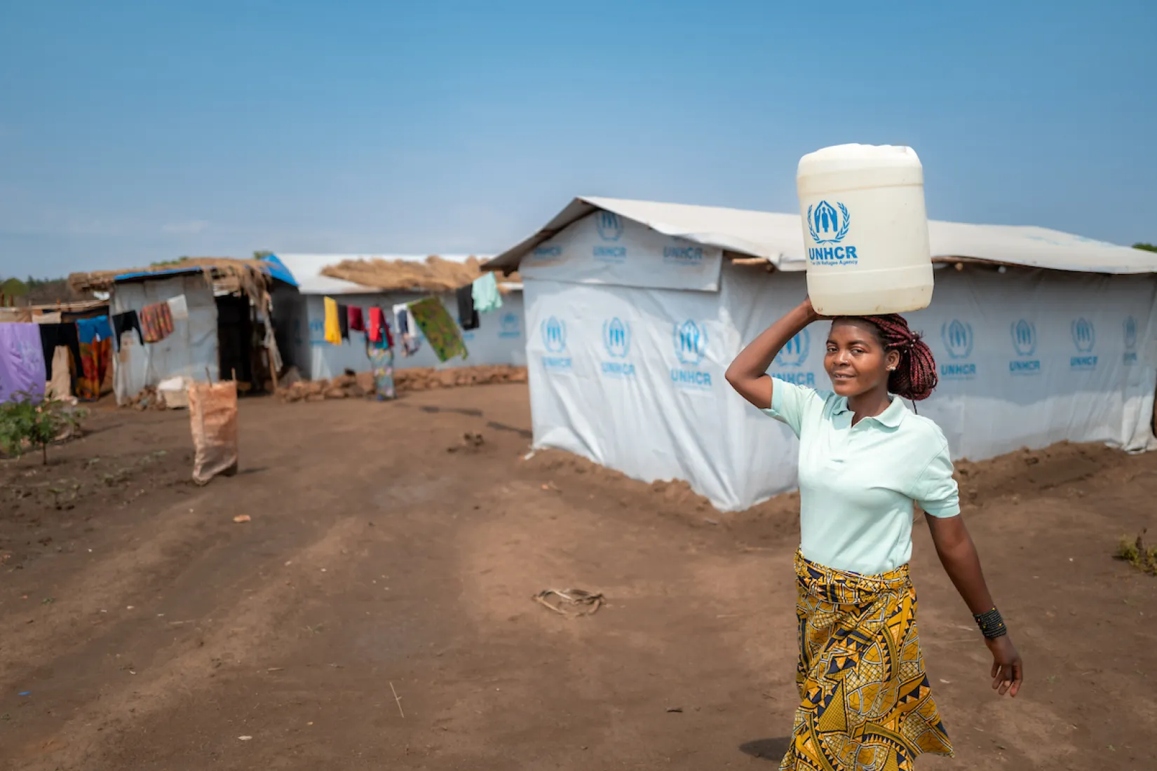 Katembo walks for water; Nyarugusu refugee camp; Tanzania, Africa