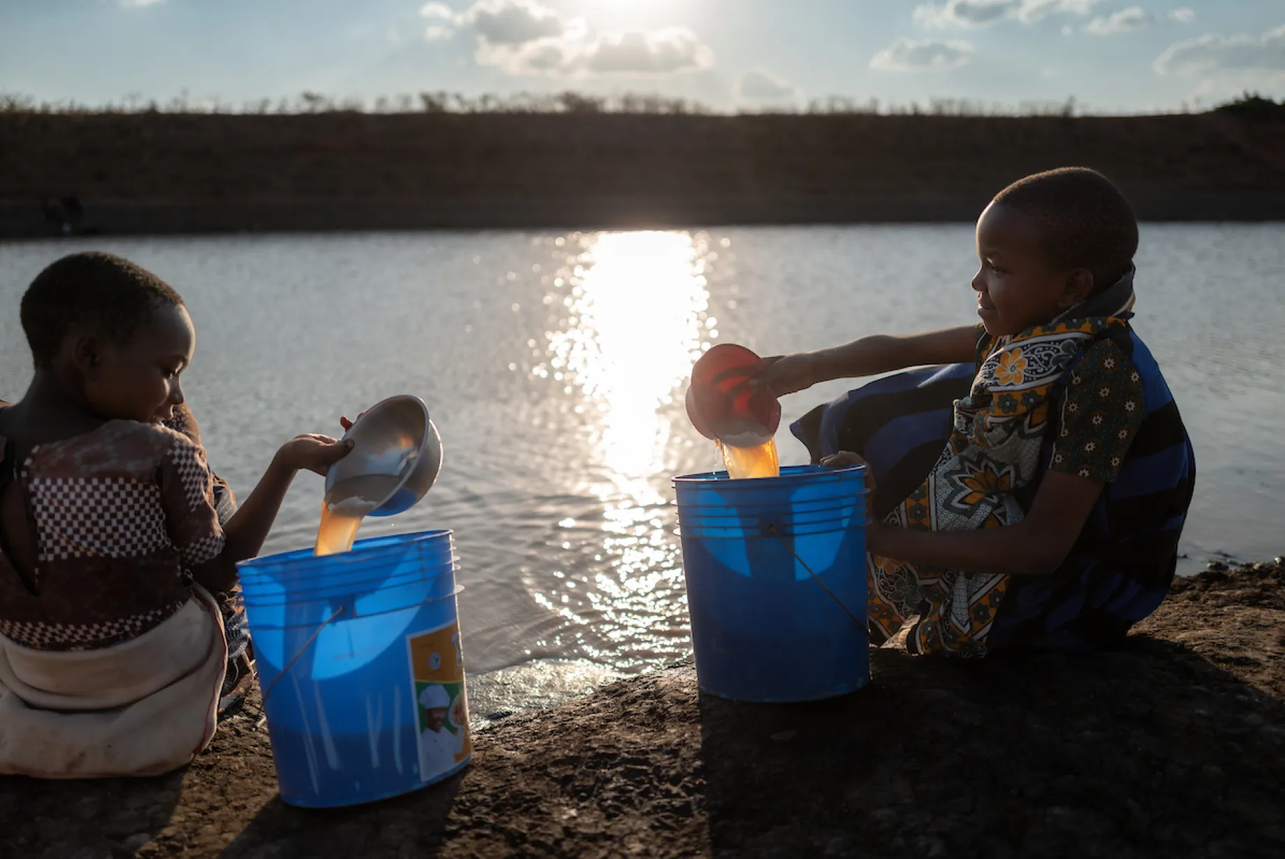 Children in Tanzania, Africa collect unsafe, dirty water