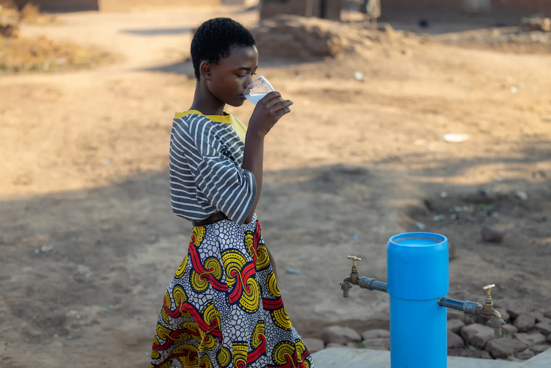 Gladys at a tapstand in Malawi