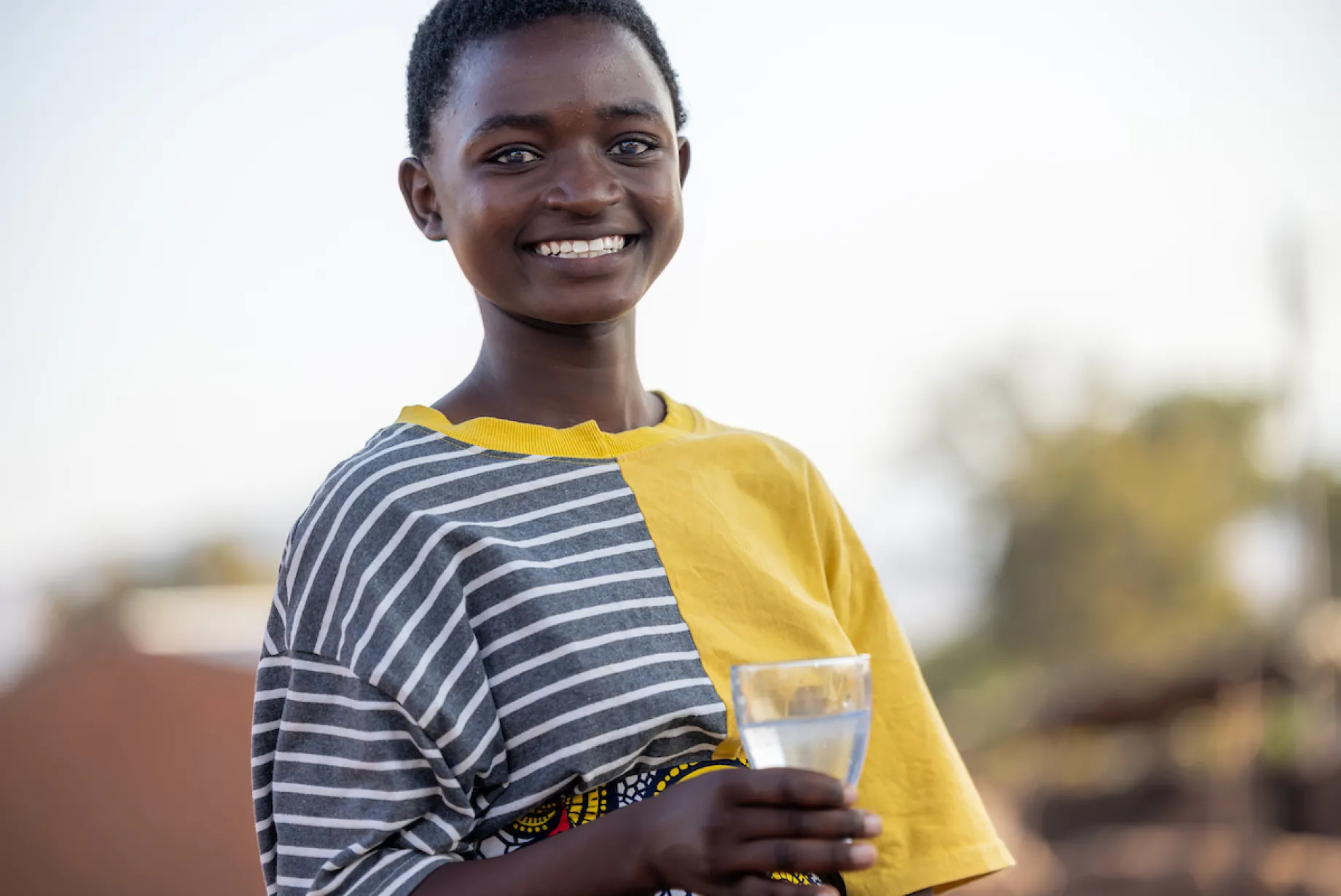 Gladys with a glass of safe water in Malawi