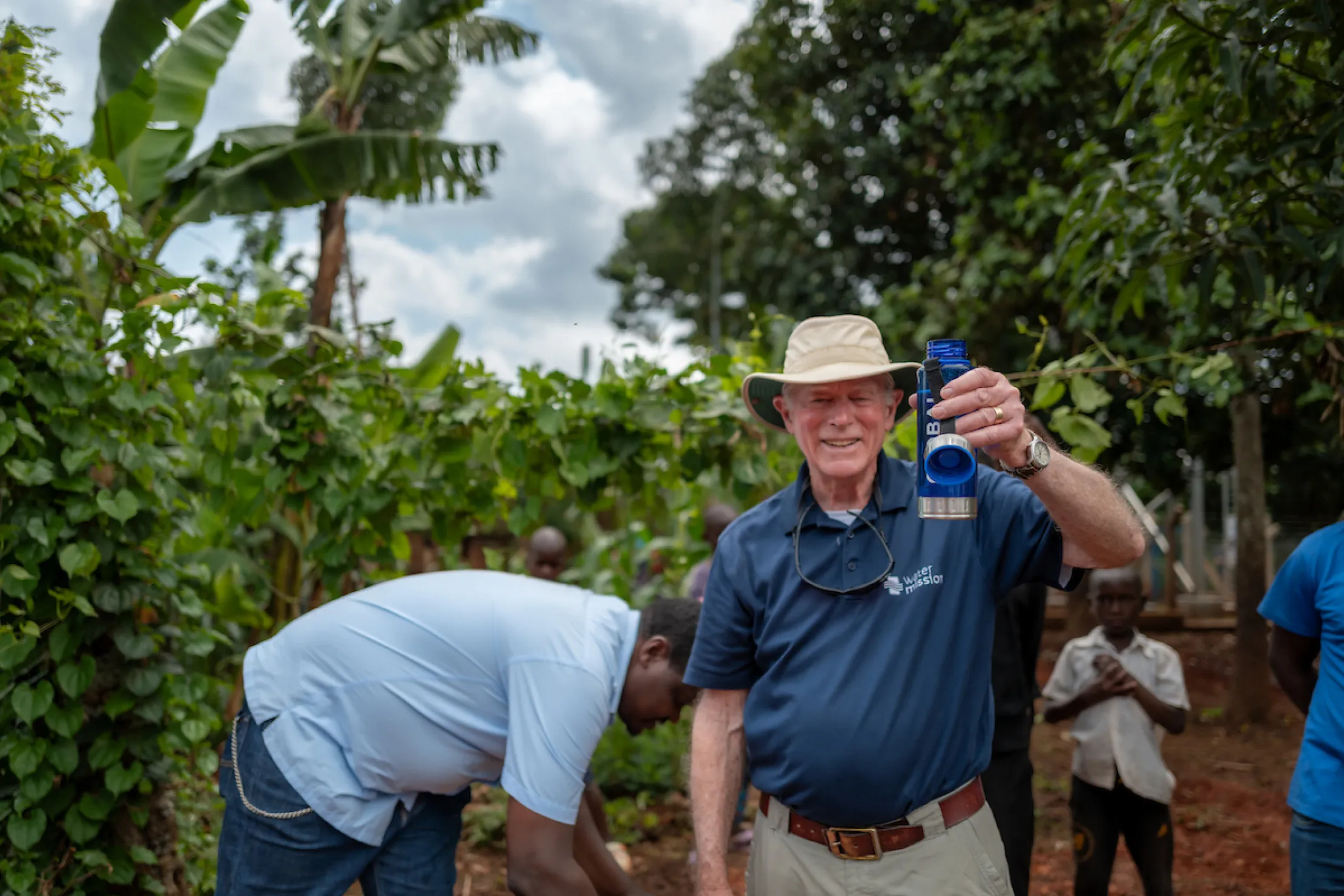 Co-founder George Greene III holds up a bottle of safe water
