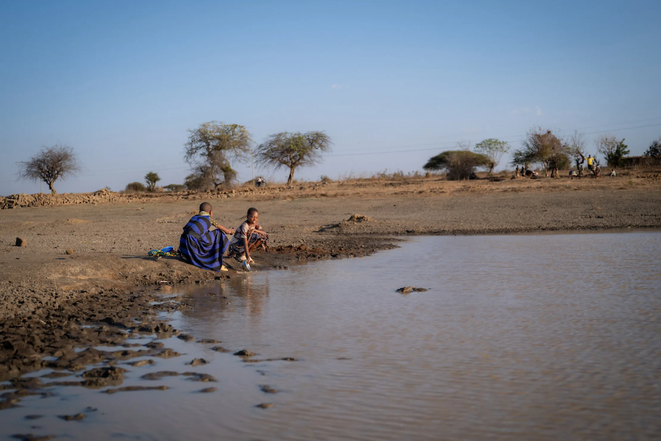 Children in Tanzania, Africa at a dirty water source