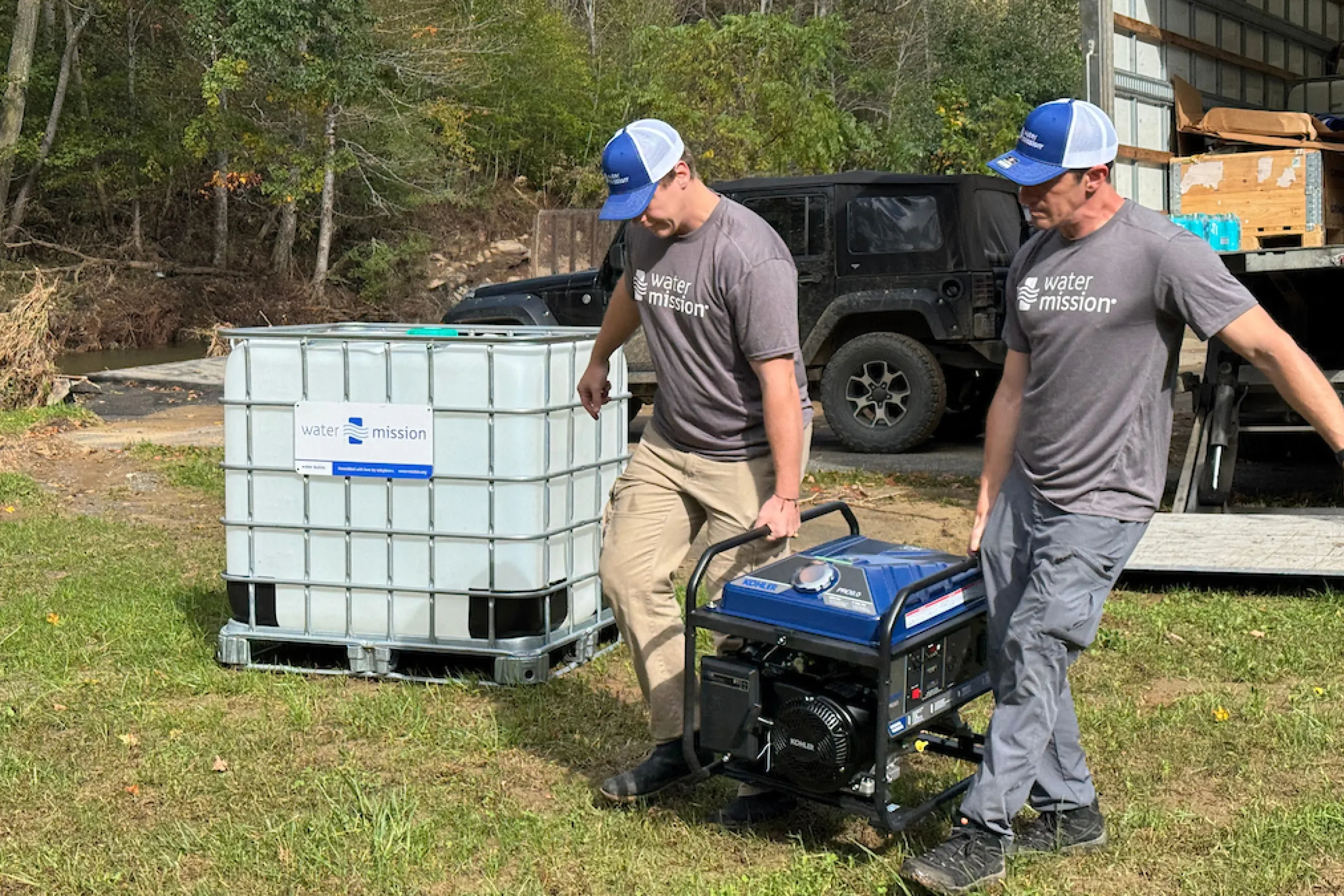 Water Mission volunteers carry generator