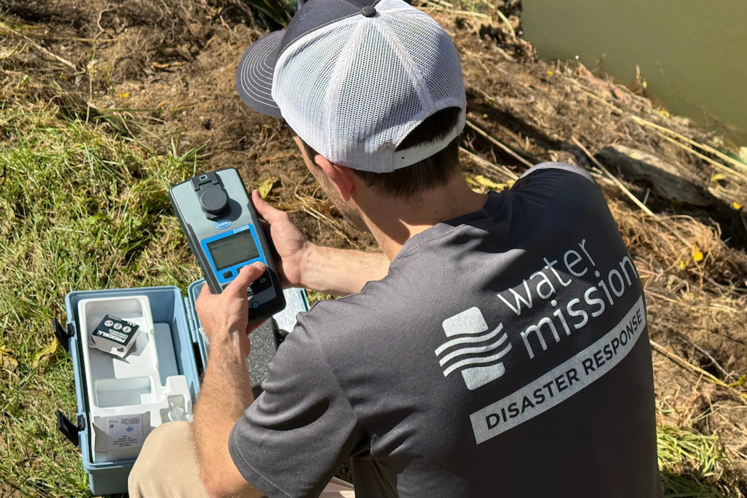 Water Mission staff member testing water