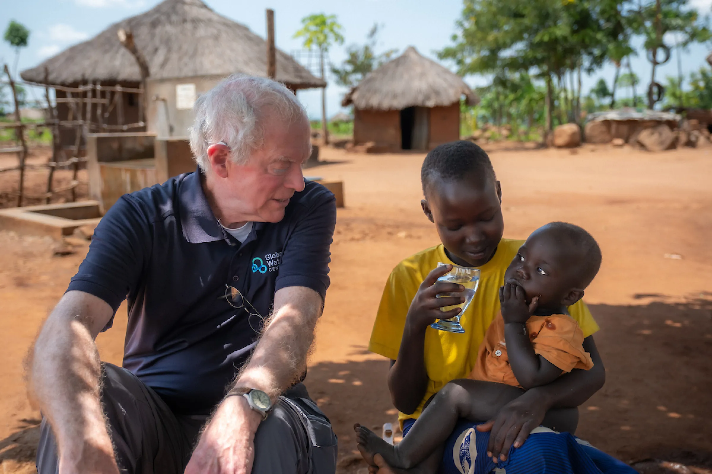 George Greene III and a refugee family in Uganda